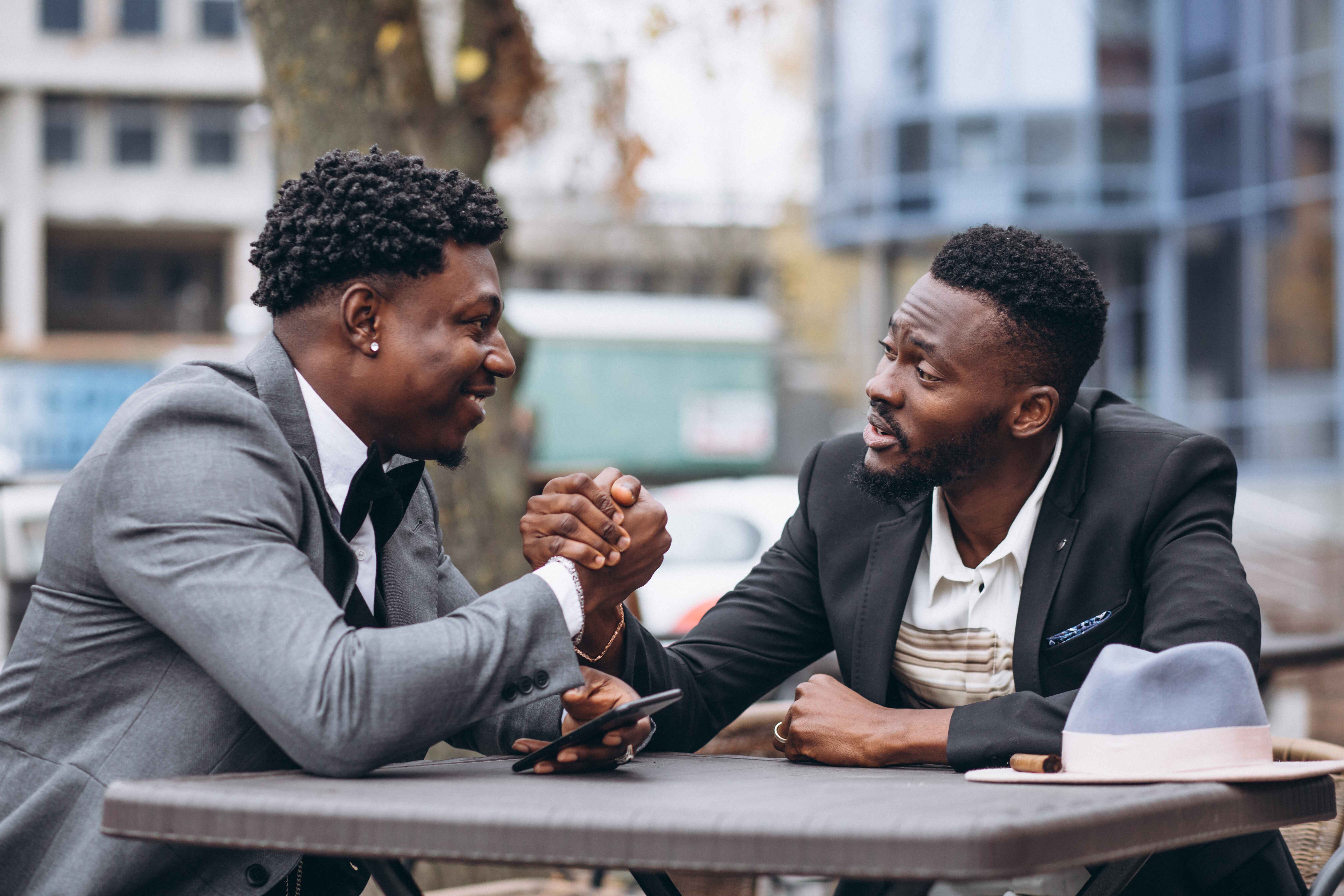 Two men sitting outside a cafe